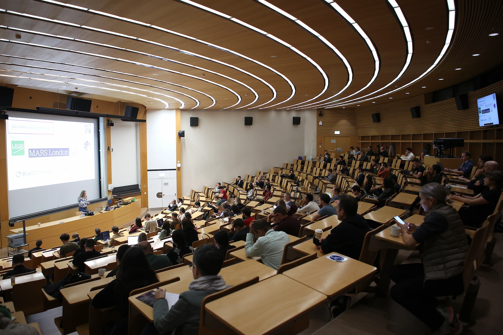 The ETH lecture hall seen from the back, most seats taken