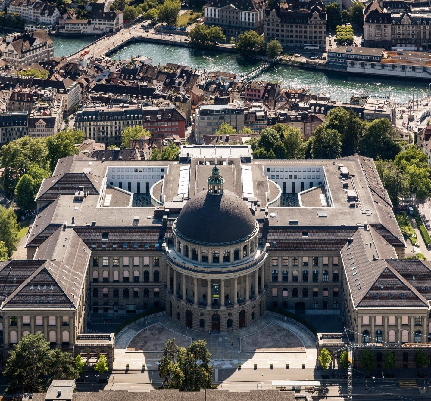 Aerial view of ETH Zurich main building with its iconic dome and symmetrical architecture overlooking the Limmat river and Zurich cityscape